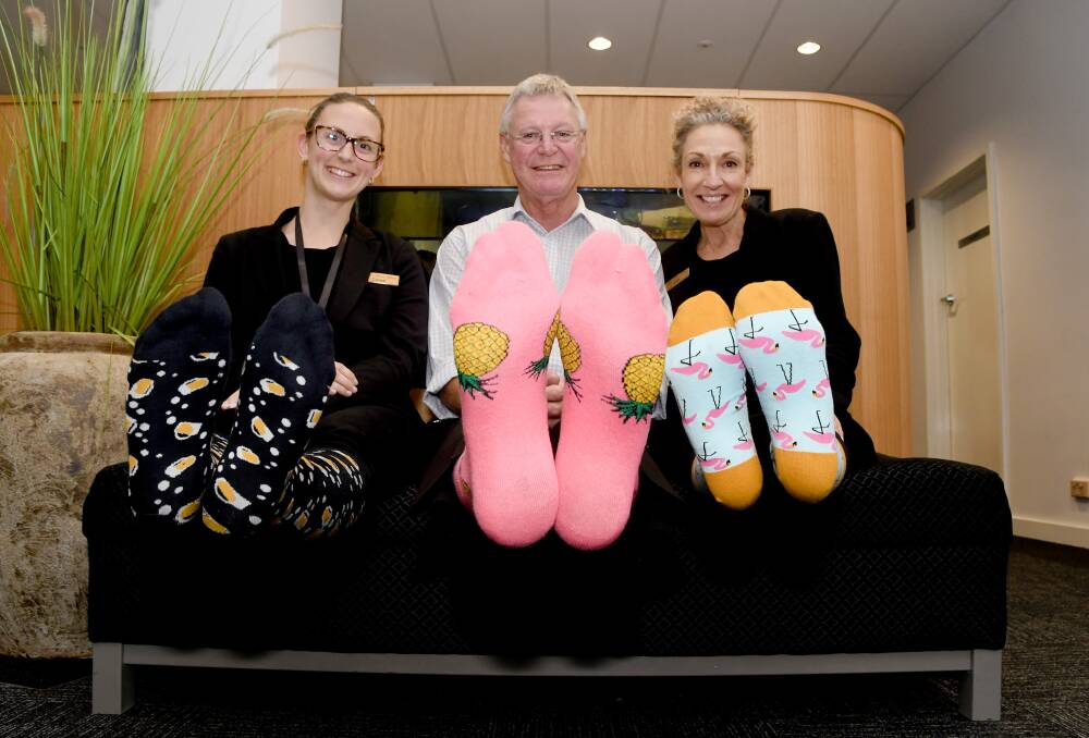 SUPPORT: Horsham Lister House Medical Clinic staff Chloe Connell, Rob Phillips and Julie Leskie-Magee wore crazy socks for to raise awareness of mental health. Picture: SAMANTHA CAMARRI