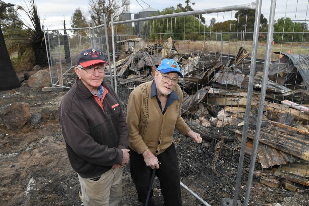 Kaniva locals Robert McKeown and Charles Pretlove with the rubble of the town's historic railway station. Picture: SAMANTHA CAMARRI