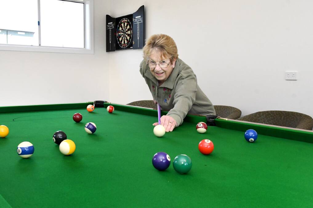 FUN AND GAMES: Wimmera Lodge Retirement Village resident Marj McKernan playing pool in the lodge's new games room. Picture: SAMANTHA CAMARRI