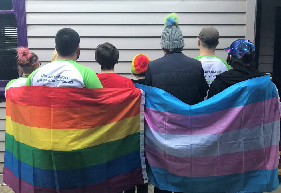 RAINBOW PRIDE: Members of Horsham headspace's Rainbow Group for LGBTI youth stand proud with their rainbow flag and trans flag. Picture: JADE BATE