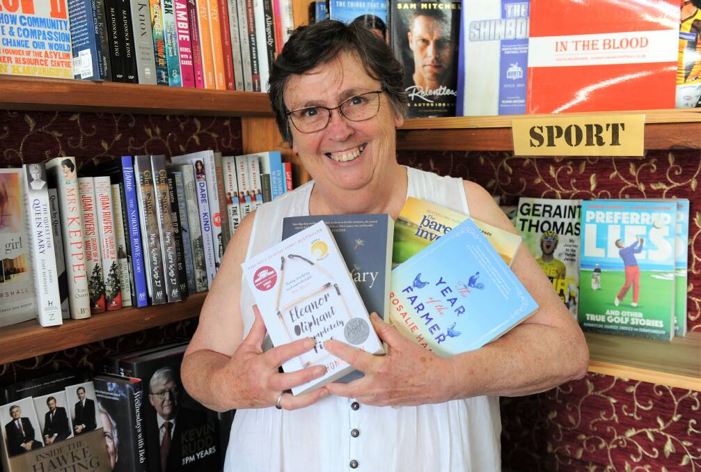 SUMMER READING: Redrock Books and Gallery owner Marian Anderson with a selection of her summer read picks for 2019. Picture: JADE BATE