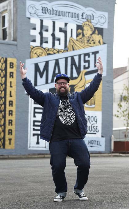 Travis Price in front of his handiwork, which was painted on a wall on Ballarat's Main Road. Picture: Lachlan Bence