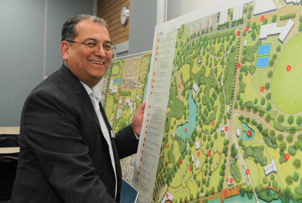 Horsham council's chief executive Sunil Bhalla with a map of the proposed City to River master plan. Picture: JADE BATE