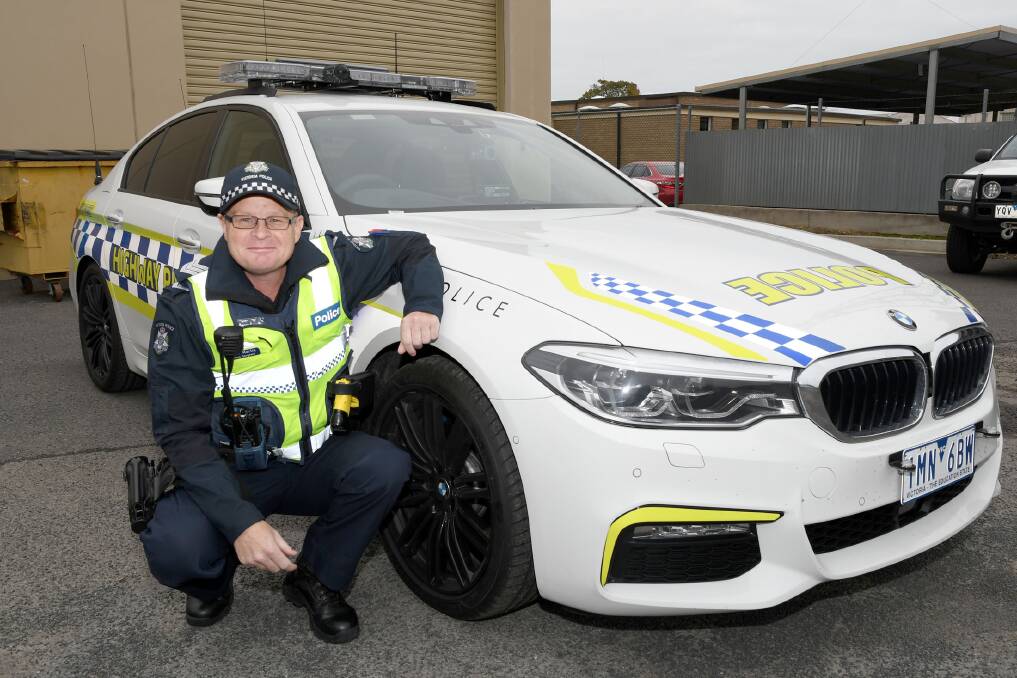 NEW LOOK: Horsham Highway Patrol Acting Sergeant Heath Martin with the unit's new BMW 5 Series sedan on Thursday morning. Picture: SAMANTHA CAMARRI