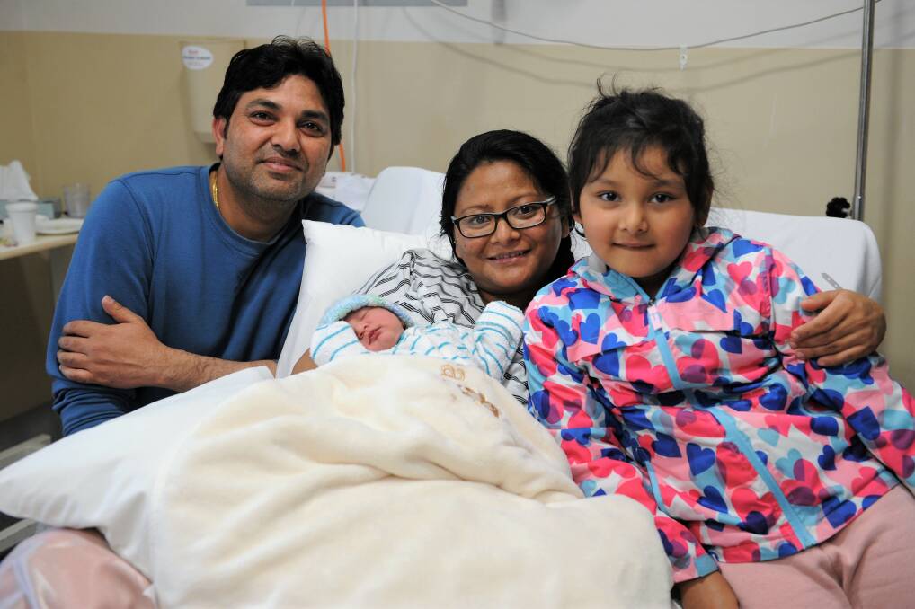 ROADSIDE SURPRISE: Baby Arshika "Rose" Shahi was born on the side of the road on Tuesday morning. She is pictured here with her parents Ashish Shahi and Mahima Atwal, and older sister Archisha Shahi, 5. Picture: JADE BATE