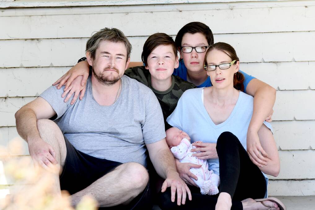 Tim Shaw and Kirstie Rogers with their three children Alex Rogers, 12, Eli Rogers, 15, and Evie Shaw, 2 months, have lost their Clear Lake home in a fire. Picture: SAMANTHA CAMARRI