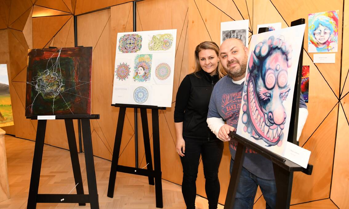 ART SHOWCASE: Uniting Wimmera's mental health team members Amy Paton and Paul Dickerson with artwork from the Mental Health Week Art Show. Picture: SAMANTHA CAMARRI