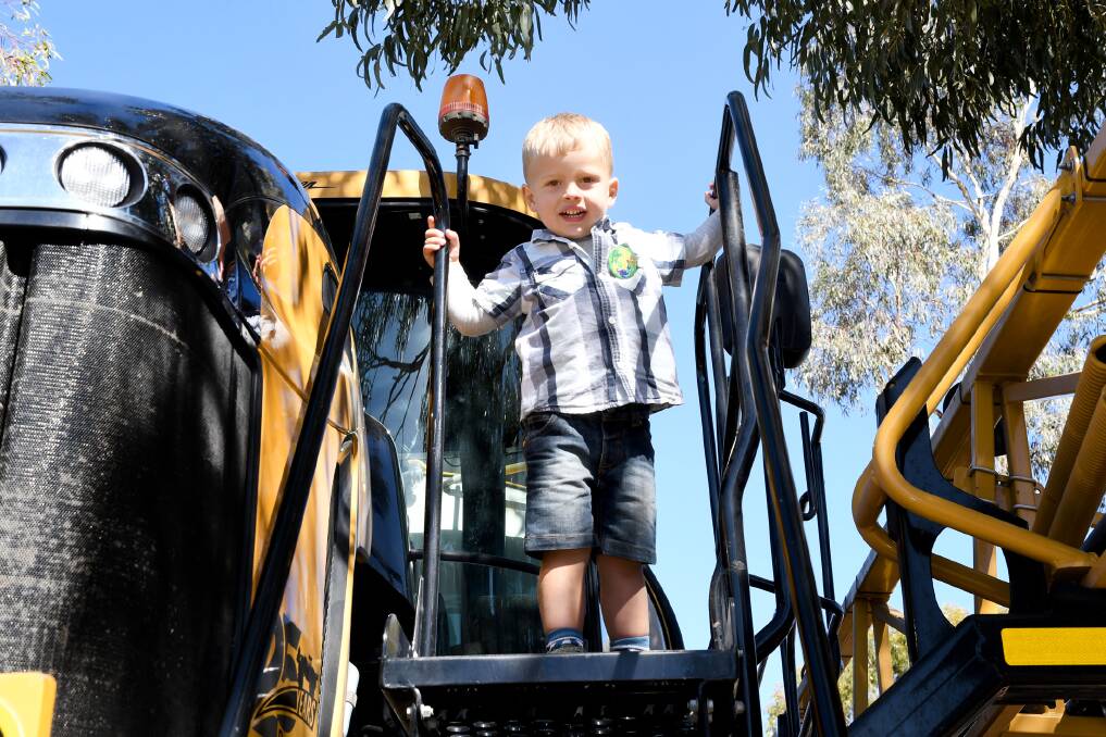 Luke Perris, 3, Kewell, checking out a new tractor at the Wimmera Machinery Field Days on Thursday. Picture: SAMANTHA CAMARRI