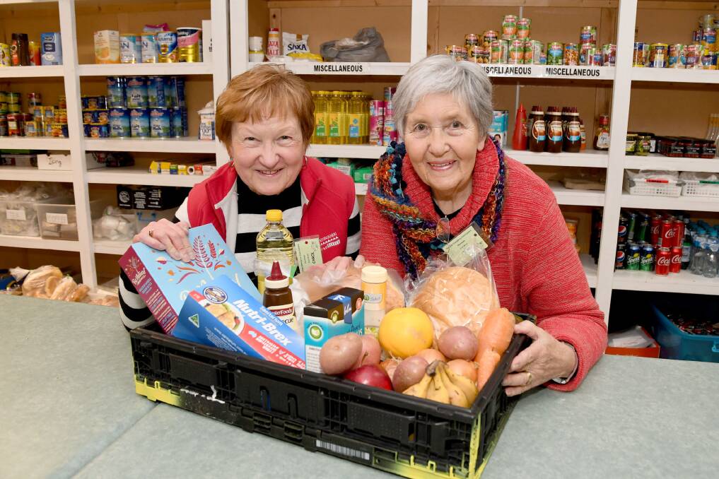 Horsham Christian Emergency Food Centre volunteers Carol McDonald and Jean Combe with a food hamper. Picture: SAMANTHA CAMARRI