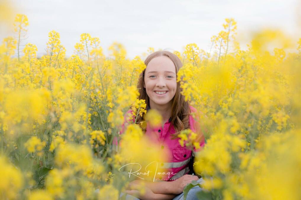 CROP: Cassie Hately in a canola paddock at her family's Natimuk farm. Photo was taken in September. Picture: WENDY ELLIS, Rural Image Photography