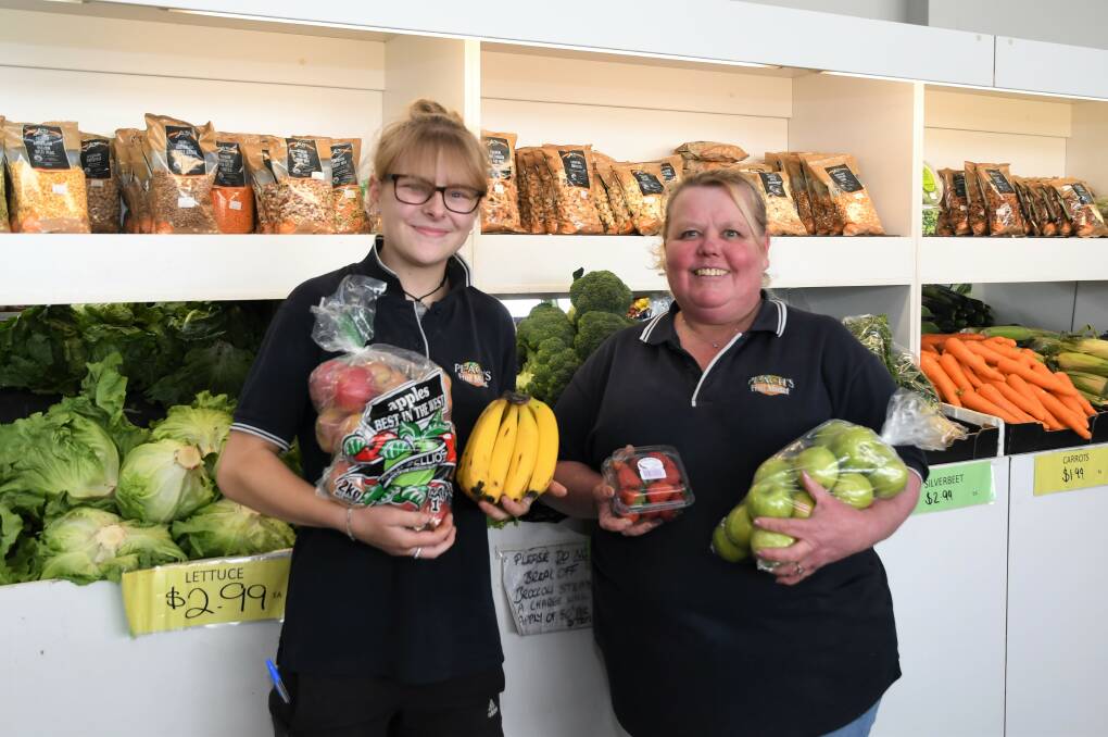 PRODUCE: Horsham's Peach's Fruit Market employee Kayla Buckley and owner Janette Griffiths with a selection of fruit and vegetables. Picture: JADE BATE