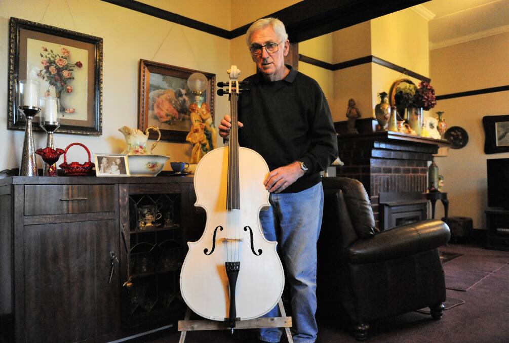 INCREDIBLE CREATION: Kaniva resident Murray Wills with the cello he made from scratch. Mr Wills plans to start making his second cello soon. Picture: JADE BATE