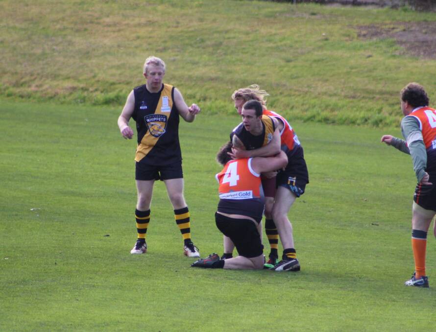 TACKLE: Grampians Giants players wrap up a Wimmera Whippets opponent. Picture: LACHLAN WILLIAMS