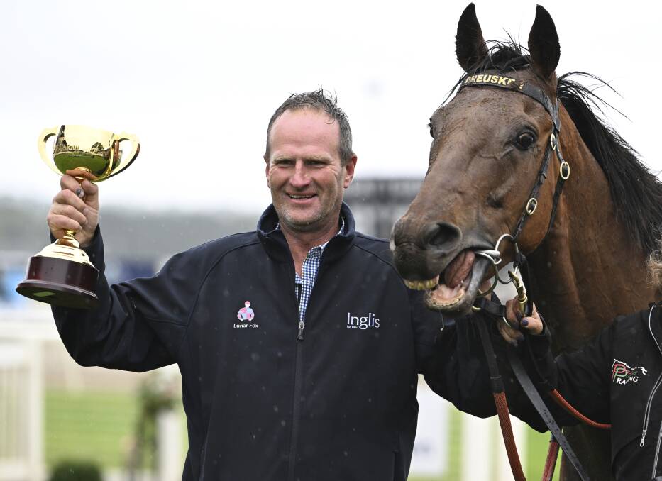 Triumphant Horsham trainer Paul Preusker with Captain Envious and the 2023 Sportsbet Ballarat Cup. Picture by Lachlan Bence.