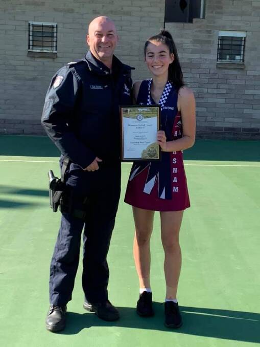 ENTHUSIASTIC: Senior Constable Troy Curran congratulates Horsham Demons under 17 netballer Molly Lakin on her round 6 Spirit of Netball Award. Picture: Supplied