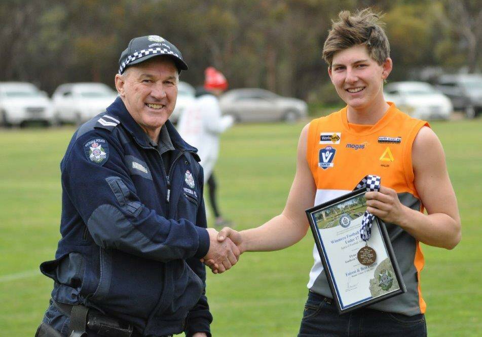 HONOUR: Southern Mallee Giants under 17 footballer Flynn Grace receives his award from Hopetoun police Sergeant Phillip McClure at Beulah. Picture: SUPPLIED
