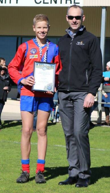 GOOD SPORT: Patrick Mills of the Kalkee under 17s was presented with his award by Horsham Detective Senior Constable Dave Richardson.