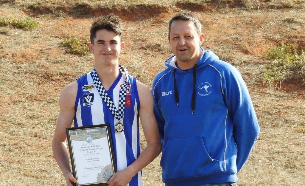 HONOUR: Under 17 player Harry Robertson is presented with his award by Harrow Balmoral footballer and Horsham police officer Senior Constable Tim Crick.