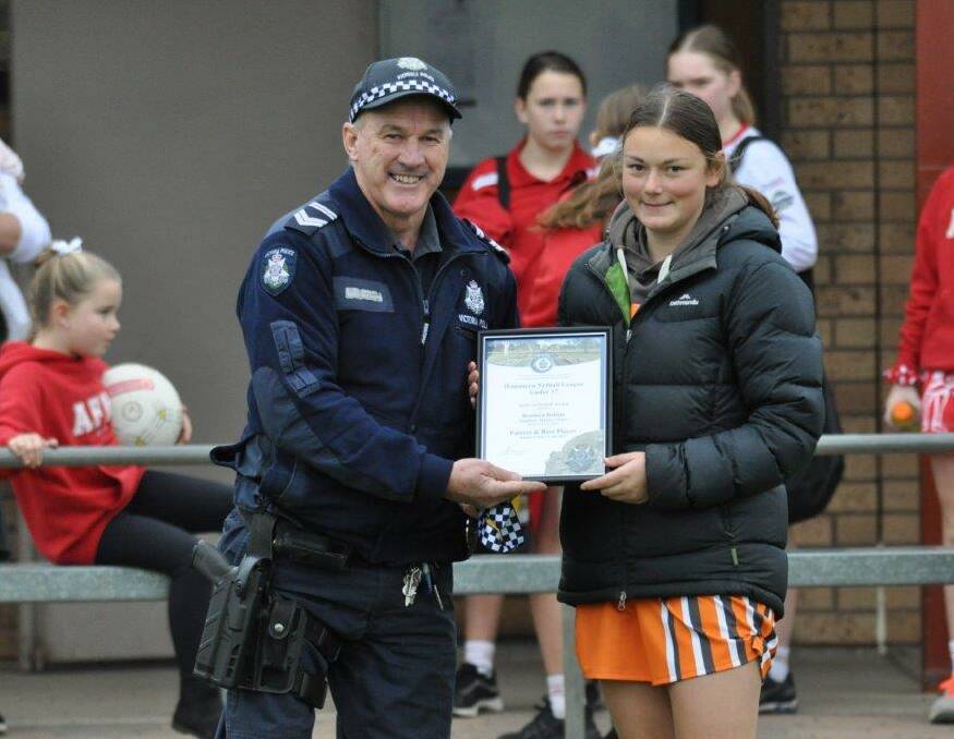 HONOUR: Southern Mallee Giants netballer Brooklyn Hallam receives her award from Hopetoun police's Sergeant Phil McClure. Picture: SUPPLIED