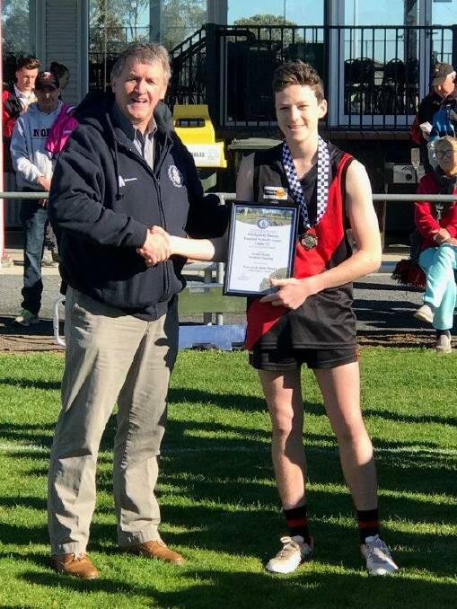 HONOUR: Declan Bushby of Noradjuha Quantong is presented with his award by Horsham Blue Ribbon Foundation member Les Power.