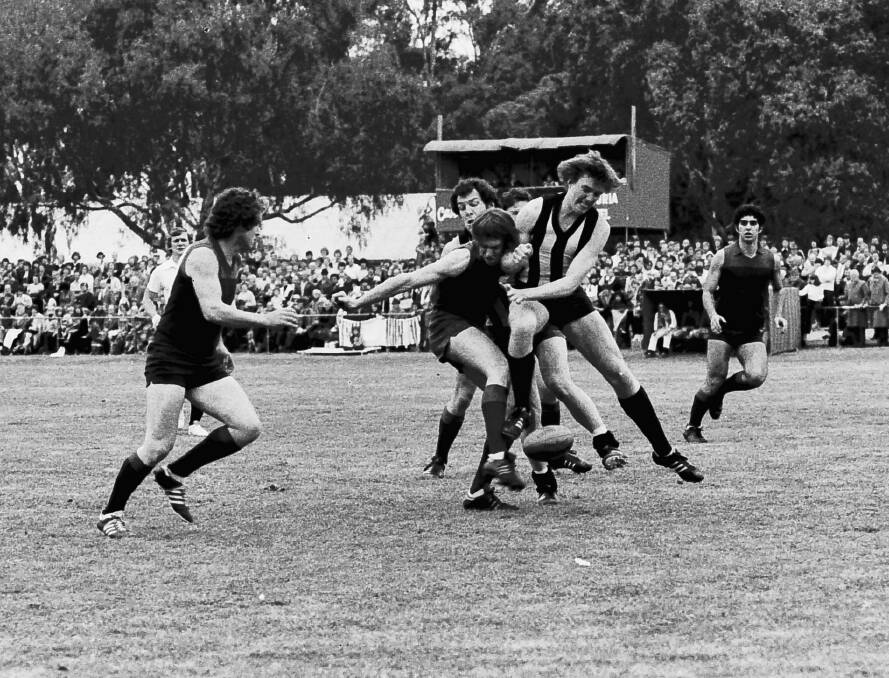 Horsham and Murtoa players clash in the middle of the field during the 1979 grand final.