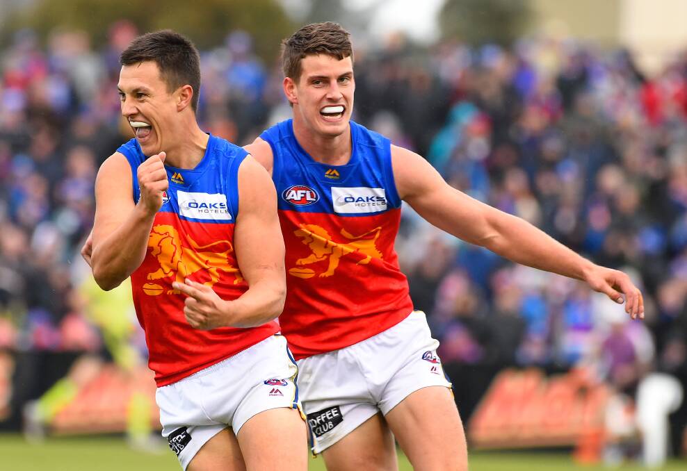 CELEBRATIONS: Jarrod Berry celebrates a goal with longtime Rebels and Lions teammate Hugh McCluggage last season. Picture: ADAM TRAFFORD/BALLARAT COURIER