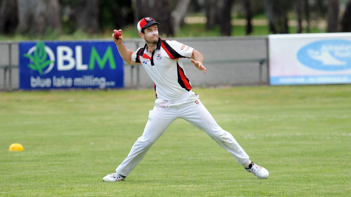 Horsham Saints' Matthew Combe throws from the boundary. 