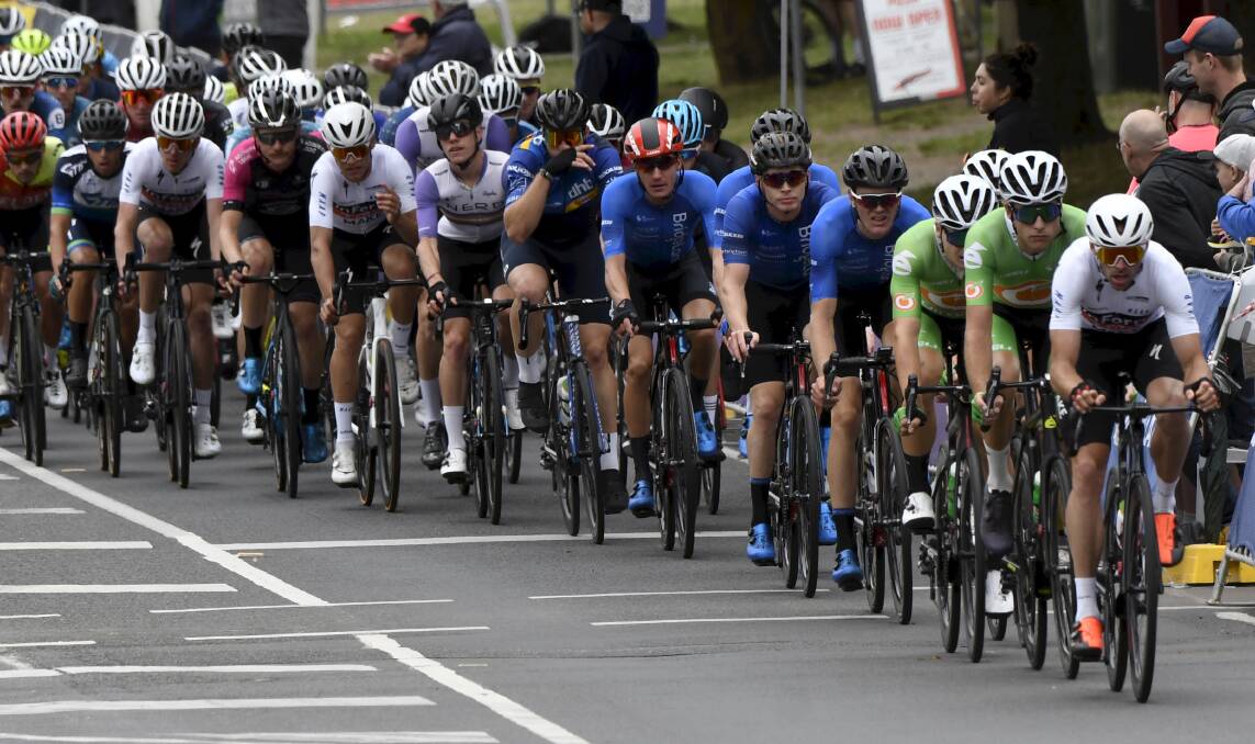 STRONG SHOWING: Horsham's Mark O'Brien (second white jersey from left, hand off the bike) in the peloton at the road national championships. Picture: LACHLAN BENCE/BALLARAT COURIER