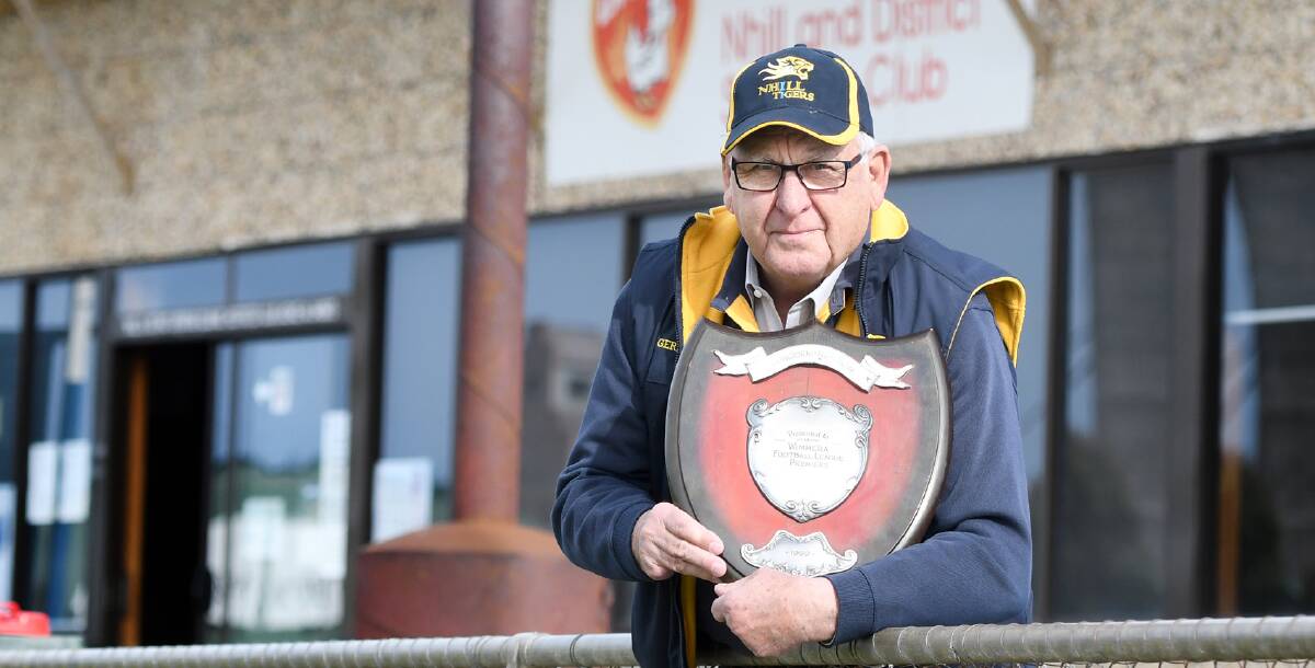 Rob Gersch holds the reminder of Nhill's 1969 success. Picture: SAMANTHA CAMARRI