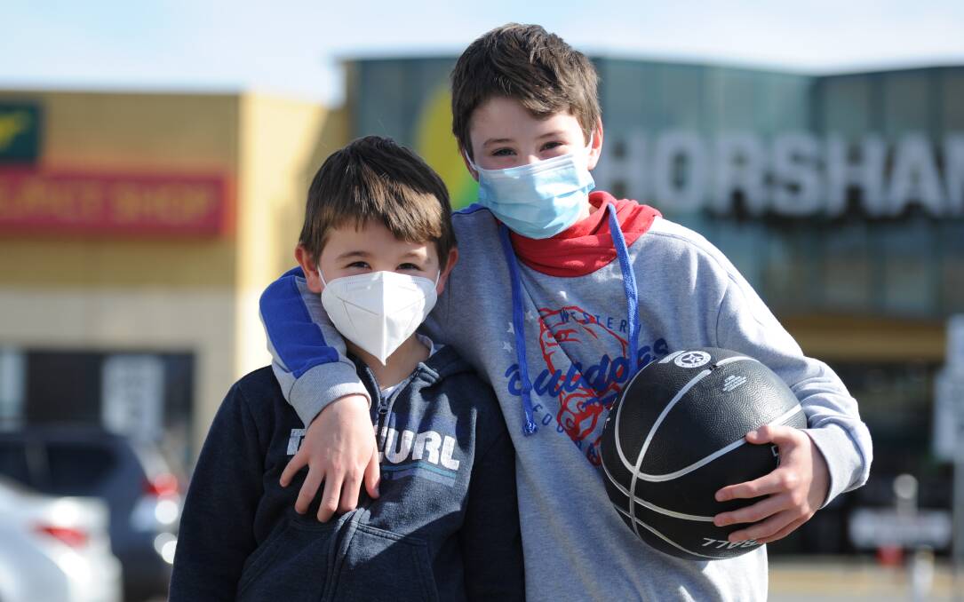 HAPPY TO PLAY THEIR PART: Bailey and Taylor Hartas wearing facemasks last month. It is not compulsory for children under 12 to wear face masks. Picture: RICHARD CRABTREE