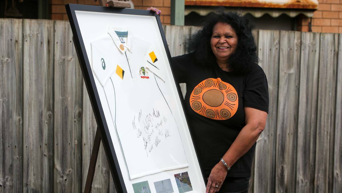 Fiona Clarke wearing a shirt adorned with the Walkabout Wickets design, next to a signed Australian shirt in 2017. Picture: ROB GUNSTONE/THE STANDARD