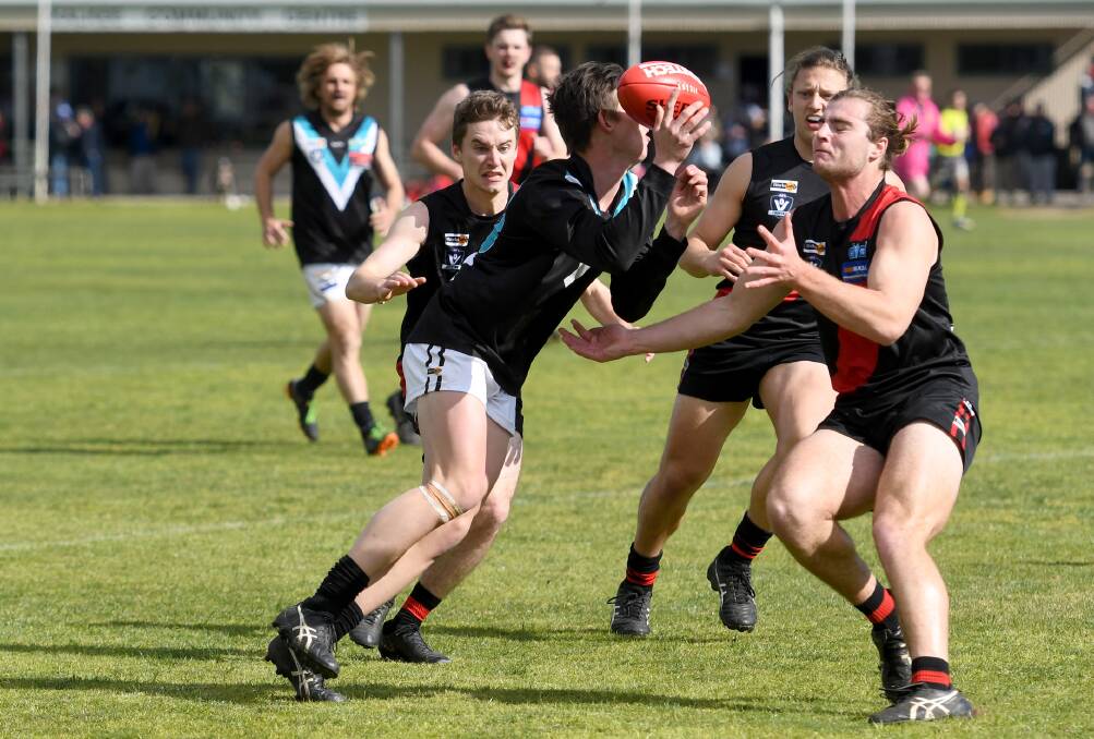 Swifts' Zac Armer and Zane Batson meet in the middle of the park. Picture: SAMANTHA CAMARRI