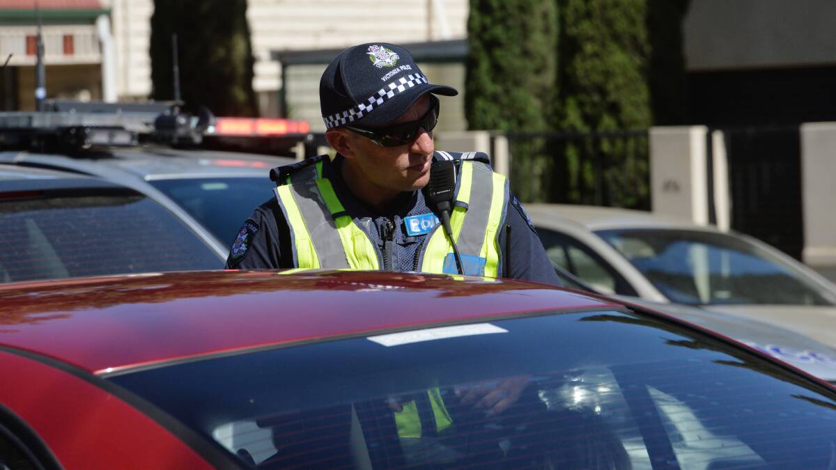 CHECKPOINTS: A highway patrol member conducts a roadside breath test. Victoria Police have established checkpoints to protect regional Victoria. Picture: FILE PHOTO