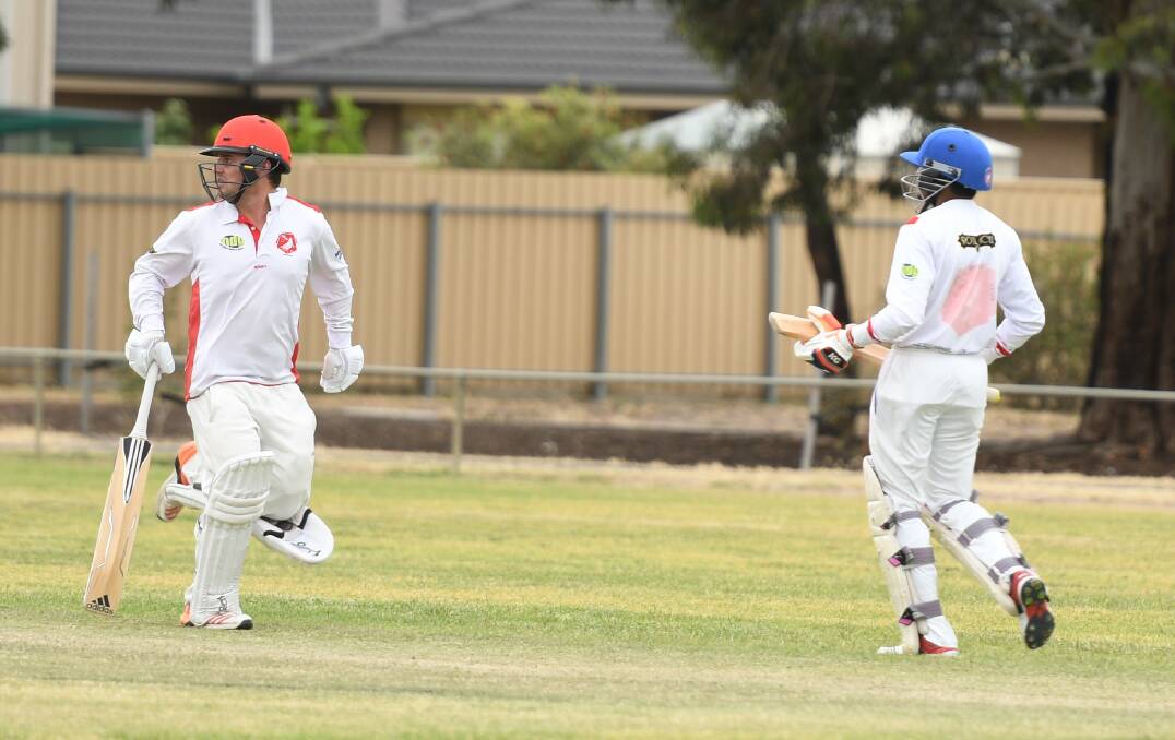 RUNS: Homers' Adam Atwood and Chaminda Gamage charge between the wickets. 