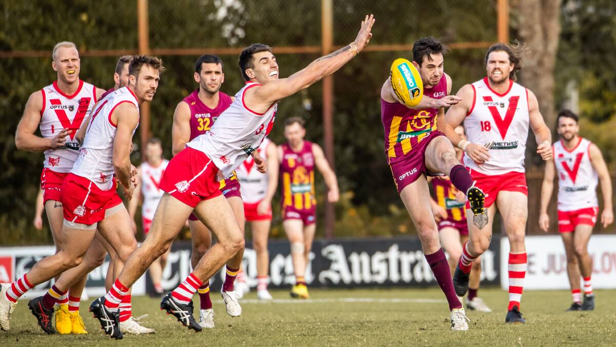 ROOST: Lachlan Delahunty gets a kick away under pressure. Picture: JACK FOLEY