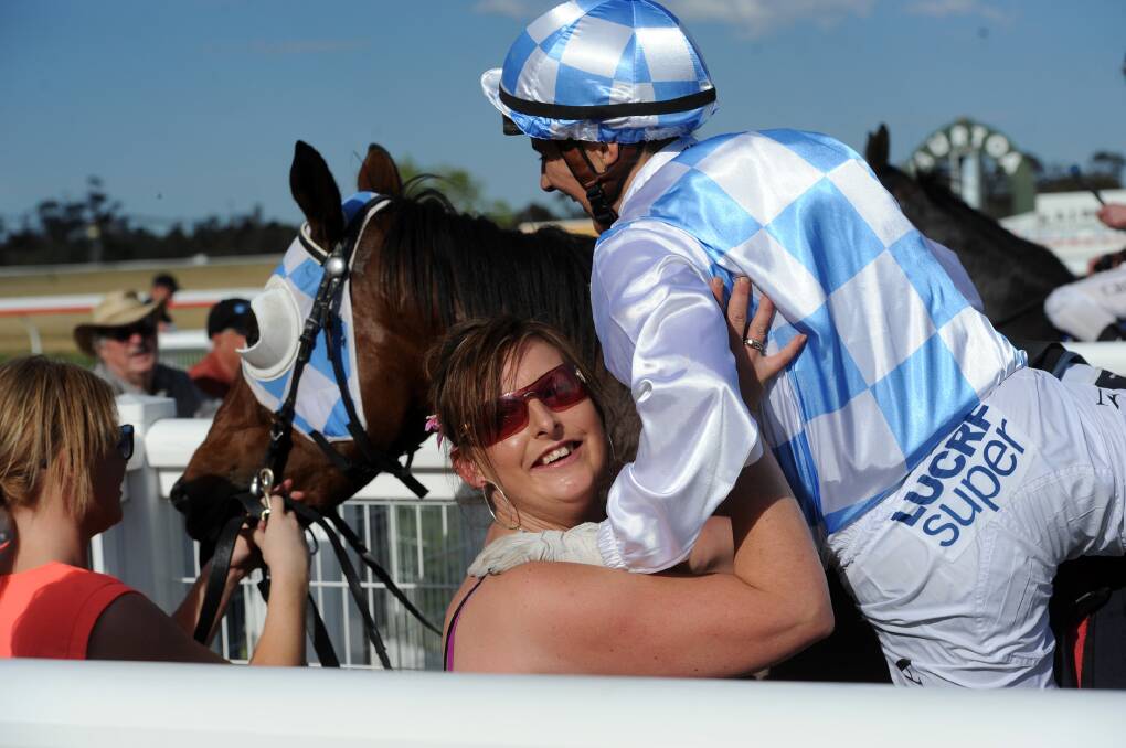 Trainer Karina O'Sullivan helps Nikita Beriman off a horse at the 2014 Murtoa Cup.
