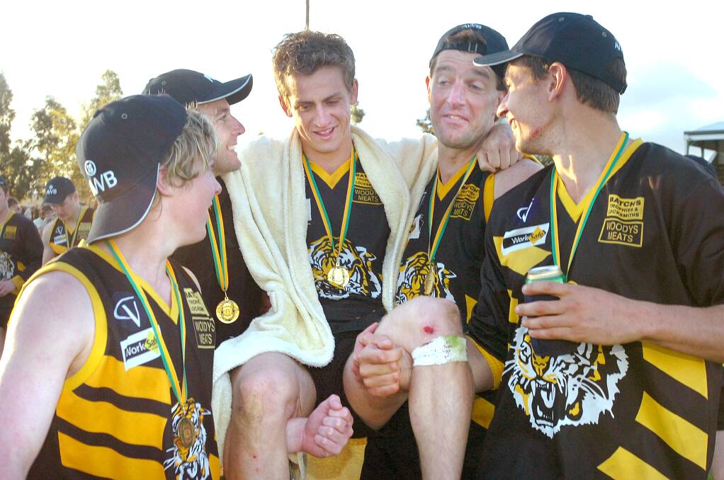Paul Leslie is carried off the field after the 2005 grand final by his teammates. 