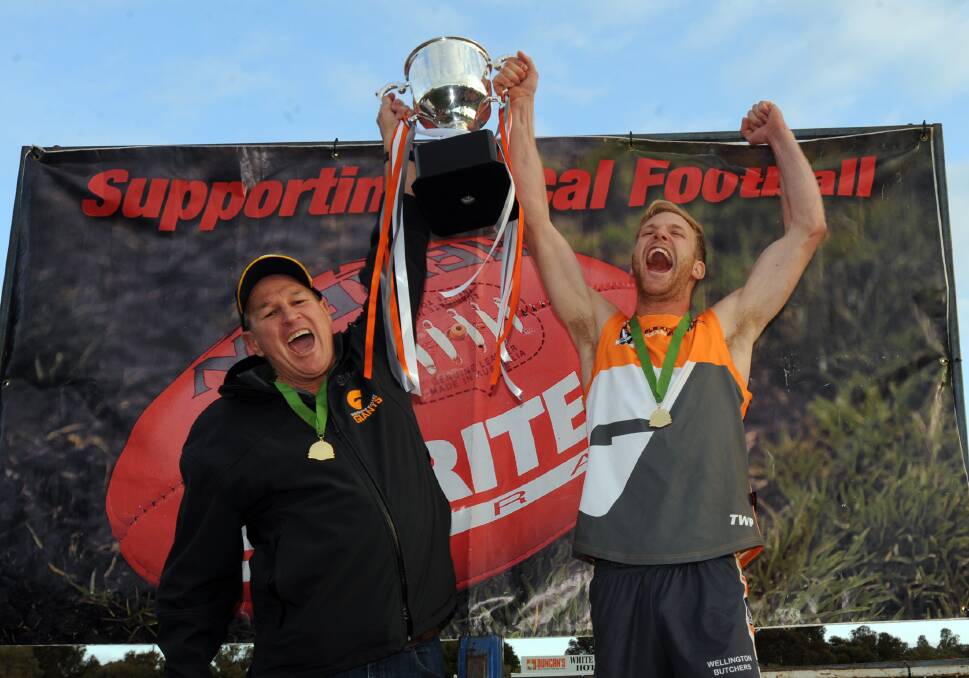 Inaugural Giants coach Geoff Burdett and Rory Shannon celebrate the 2016 HDFNL premiership, the Giants' first title as an amalgamated club. 