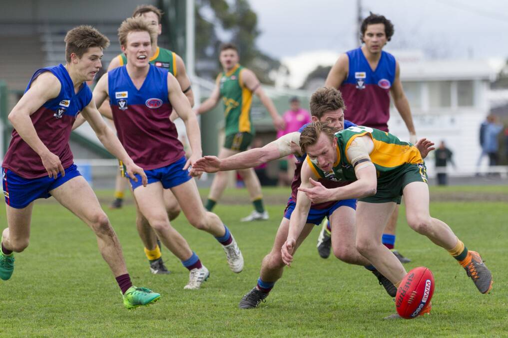 Dimboola young gun Hamish Sellens knocks the ball on in a 2019 clash against Horsham. Picture: PETER PICKERING