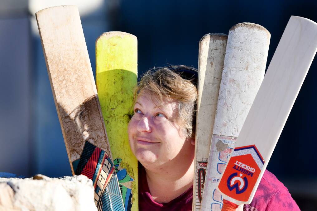 Rainbow artist Belinda Eckermann is repurposing old cricket bats to auction off with proceeds donated. Pictures: SAMANTHA CAMARRI
