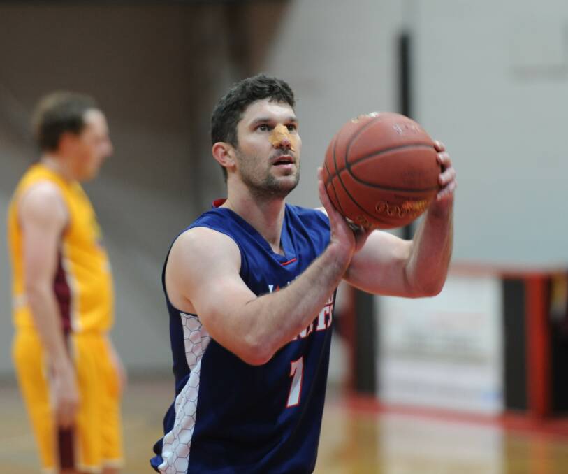 A bandaged Horsham Hornets coach Tim Pickert shoots from the line earlier this season. Picture: MATT CURRILL