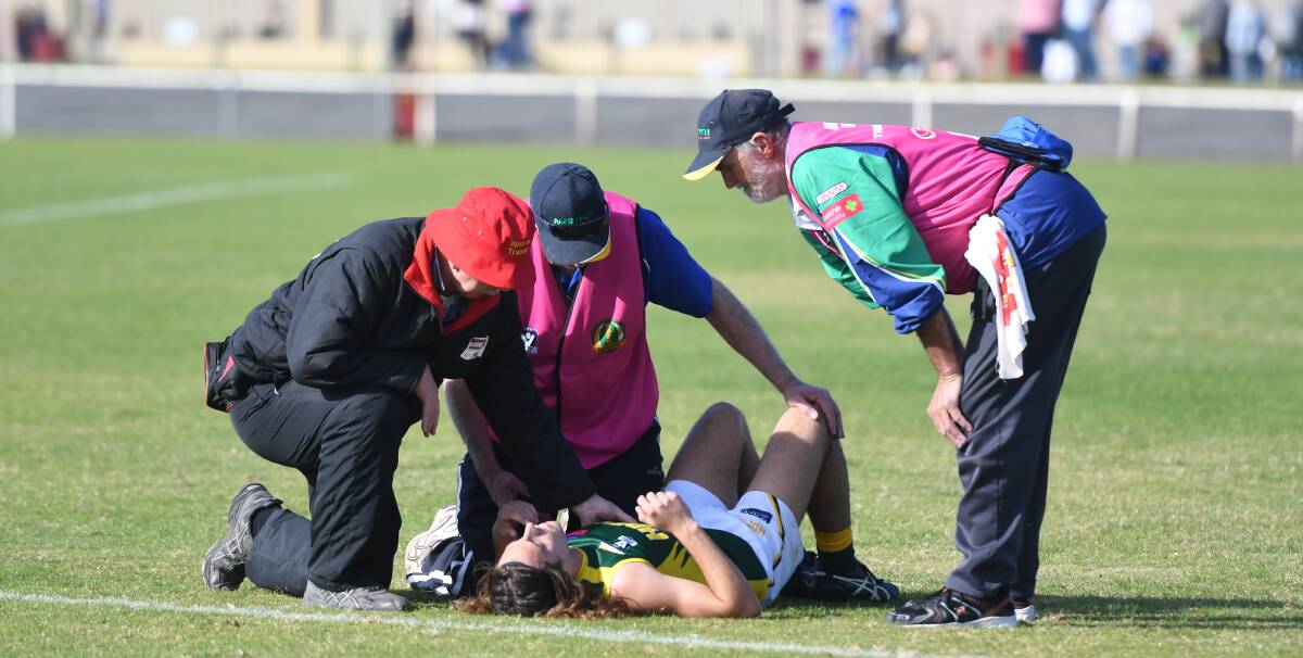 ATTENTION: Trainers attend to Jasper Gunn after he suffered a knock to the head during the Horsham District league's interleague clash against the Loddon Valley league earlier this year. Picture: RICHARD CRABTREE