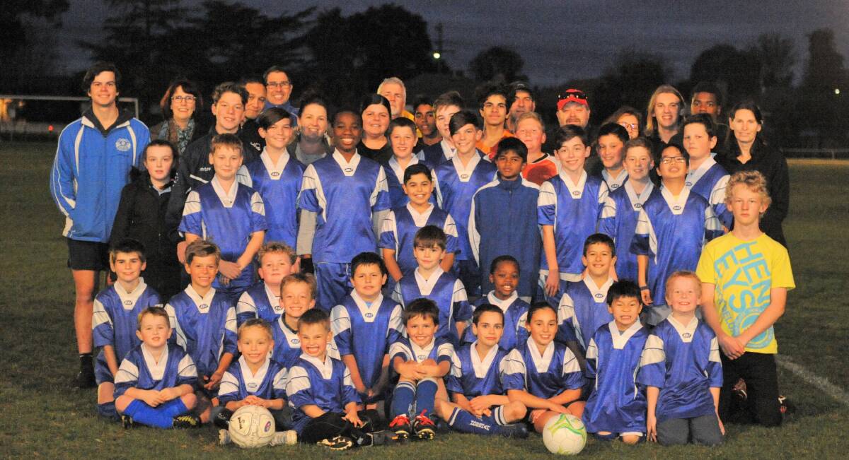Horsham & District Soccer Club's junior sides and volunteer committee members come together at training. Picture: MATT CURRILL