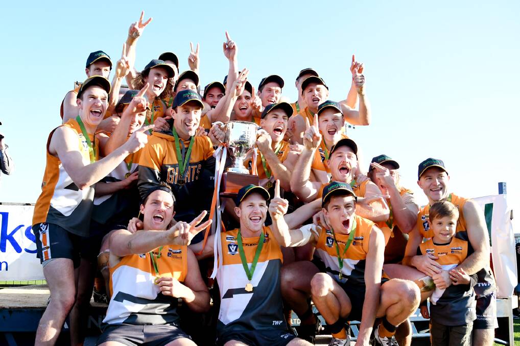The Giants celebrate a second straight HDFNL premiership in 2017.