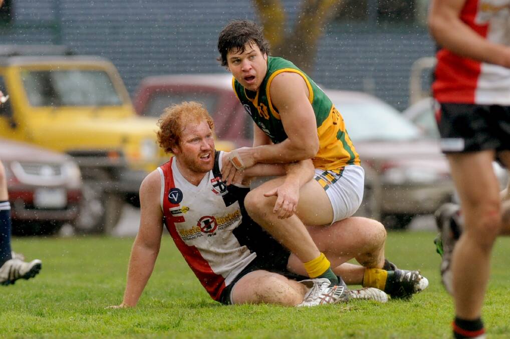 Dennis Adams and Dimboola's Lachlan Exell get acquainted in a 2013 clash. 