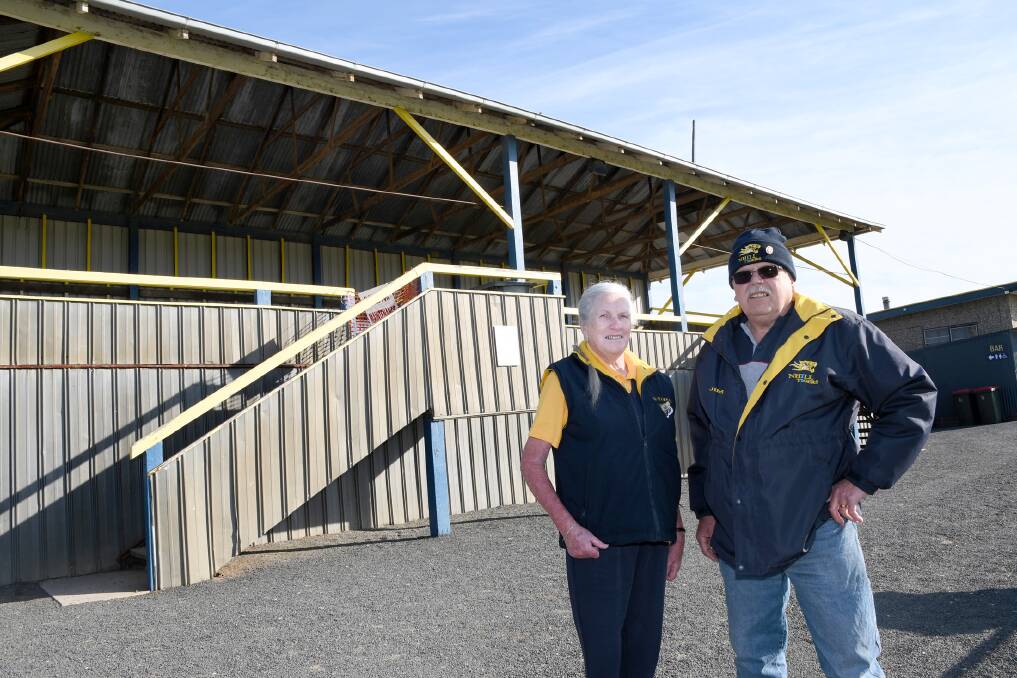Nhill and District Sporting Club life members Yvonne and Jim Gladdis, with the grandstand at Davis Park. Picture: SAMANTHA CAMARRI