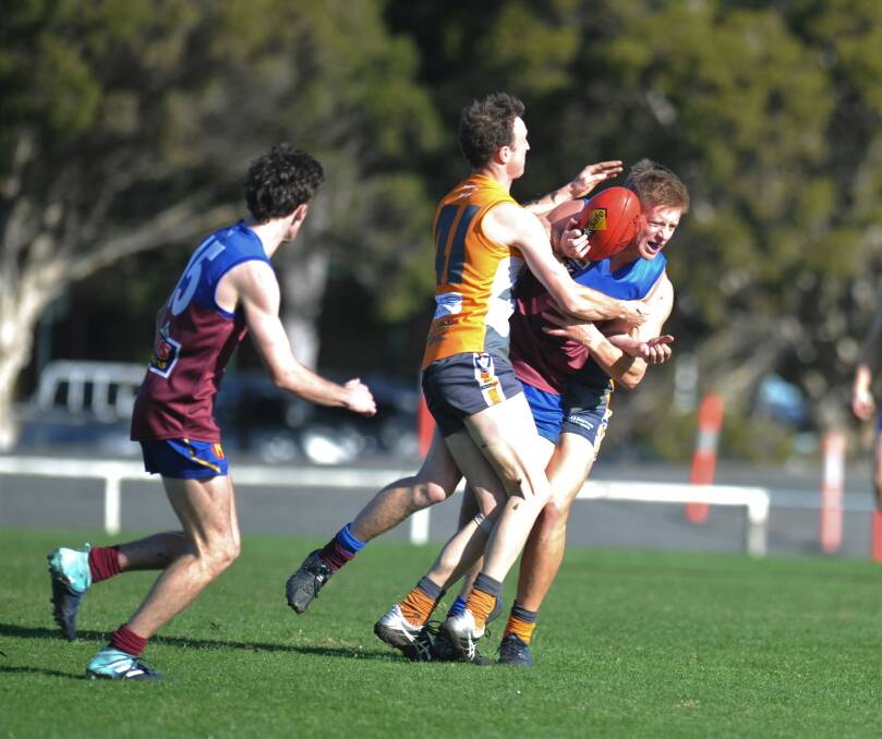 Beau Cross is sandwiched by two Giants defenders. Picture: MATT CURRILL