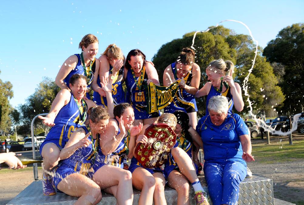 Natimuk United players are sprayed with champagne after winning the 2015 A Grade grand final. Picture: SAMANTHA CAMARRI