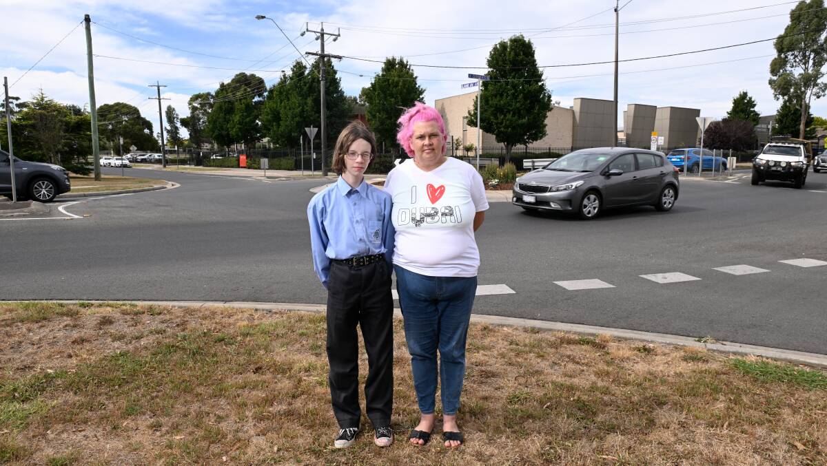 Gareth Richardson and mum Donna Curtis at the Cuthberts Road - Elaine Avenue roundabout near where he was struck by a car last year. Picture by Adam Trafford