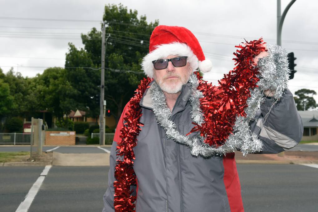 FESTIVE: Neal Salan hits back with some of his own festive spirit after council ordered tinsel be removed from a school crossing on Albert Street, Sebastopol, because it was a distraction to drivers. Picture: Kate Healy
